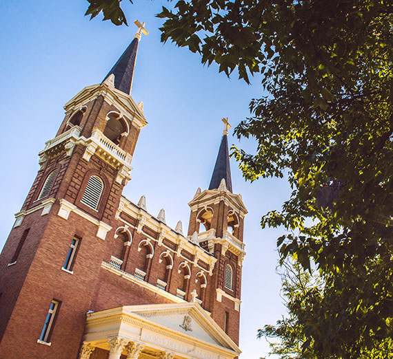 A woman sitting on a stool next to a podium
